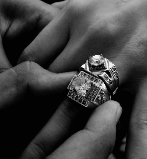 grayscale-photo-of-person-wearing-two-diamond-encrusted-724118